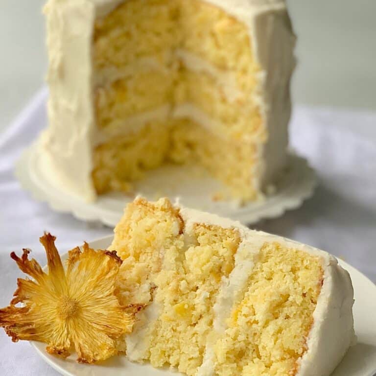 A piece of Pineapple Cake in front of the rest of the cake.