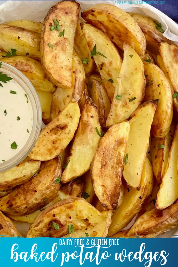 Crispy baked potato wedges on a plate with dip.