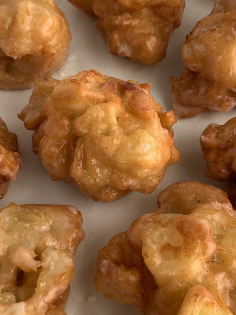 fresh fried apple fritters with a delicious glaze on top