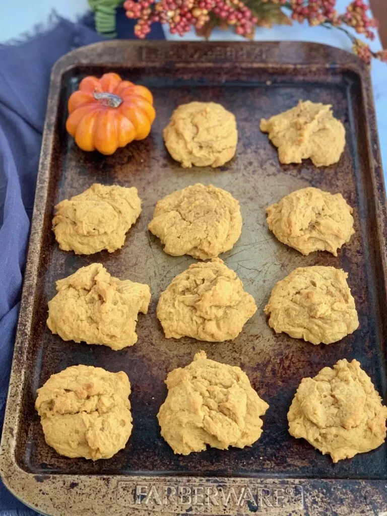 A sheet pan of pumpkin cookies before they're frosted.