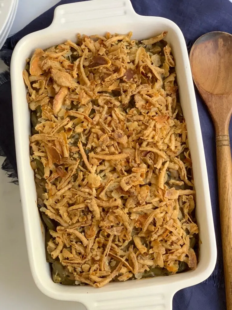 a large baking dish with creamy homemade mushroom soup with tender green beans, topped with crispy French onions.