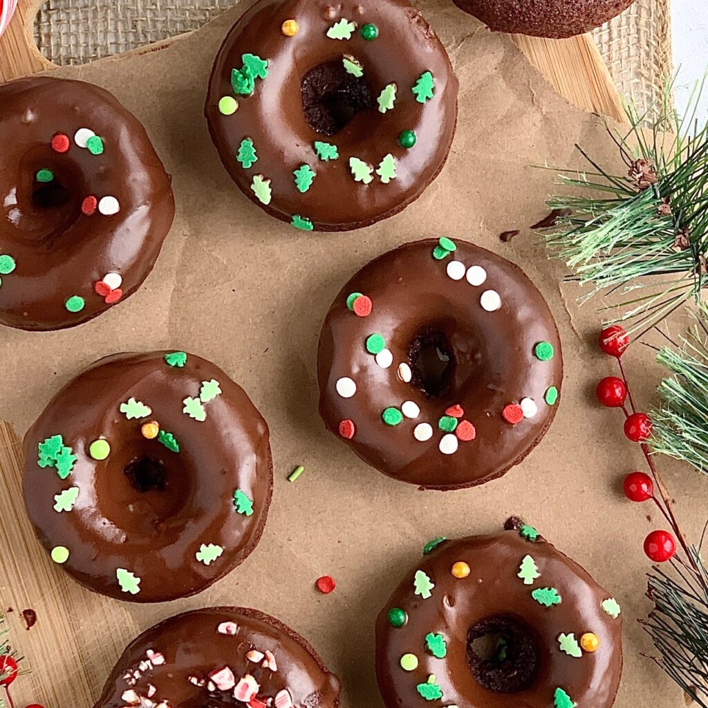Chocolate donuts with a chocolate glaze and Christmas themed sprinkles