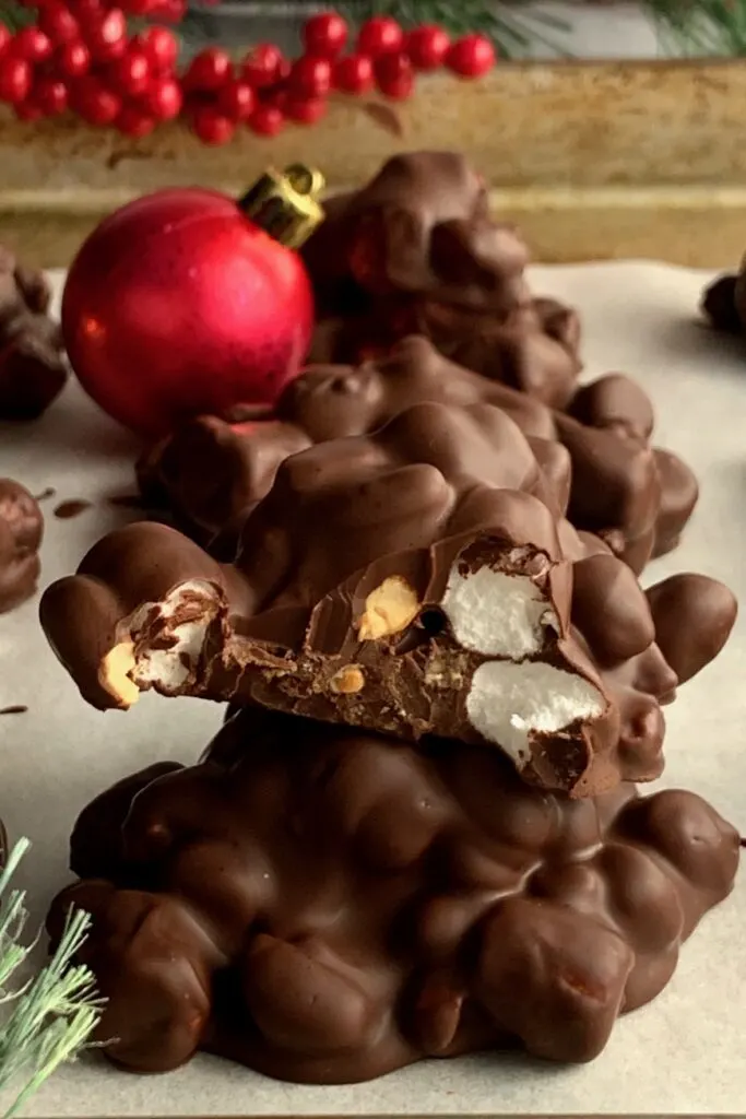 Clusters of melted chocolate around mini marshmallows and peanuts.