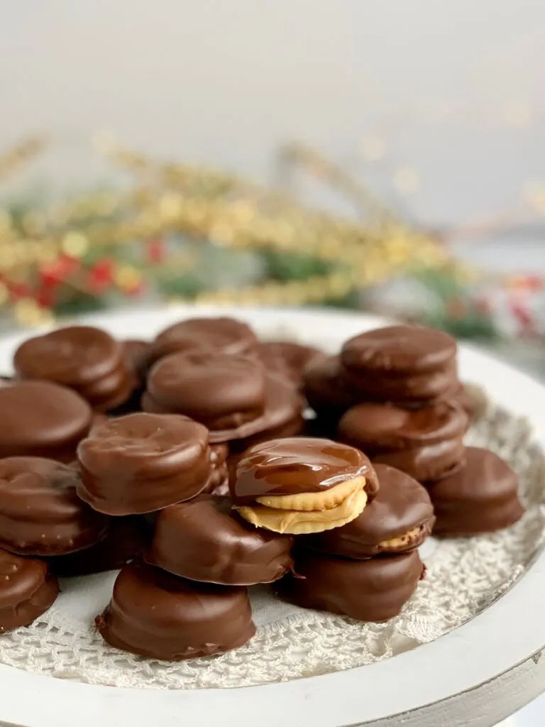 A platter full of peanut butter between two crackers then dipped in melted chocolate.