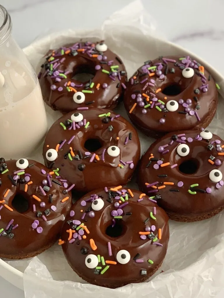 6 chocolate donuts with ganache icing and Halloween inspired sprinkles.