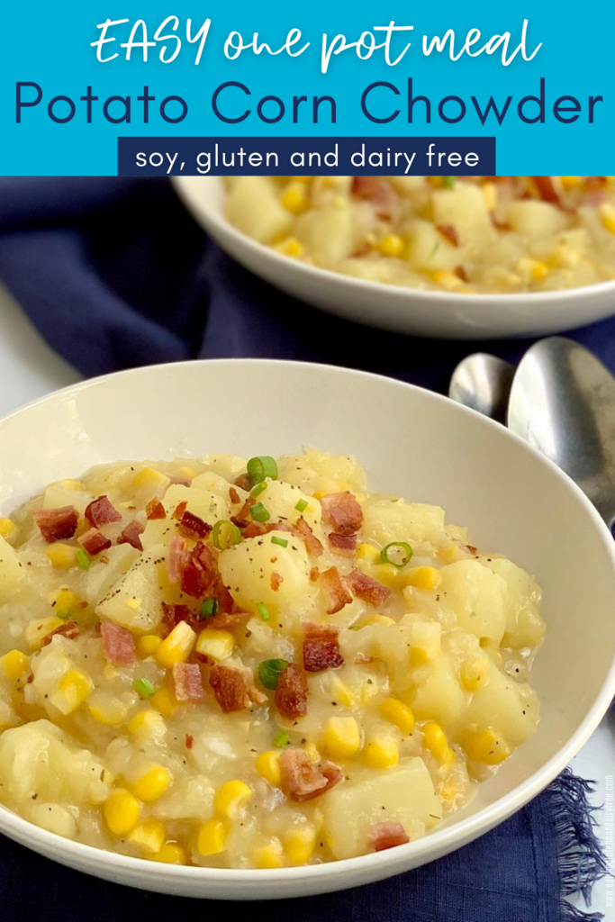 Two bowls of potato corn chowder topped with bacon buts and green onions.