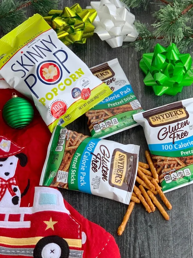 Several different allergen free snack ideas next to a red Christmas stocking.