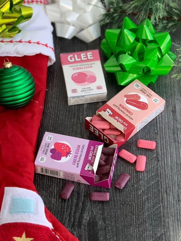 Several different allergen free snack ideas next to a red Christmas stocking.