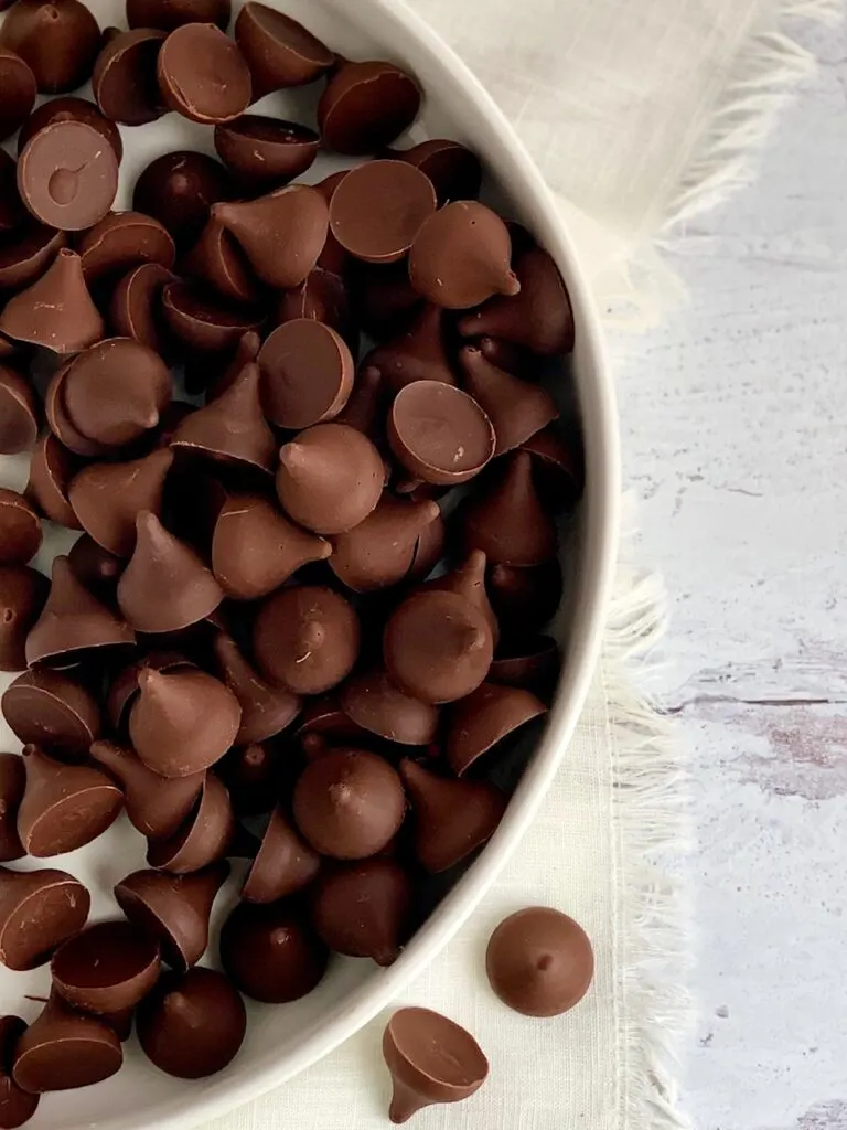 A large white serving platter filled with chocolate kisses