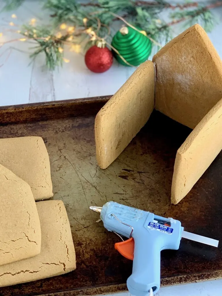 The house being glued together with a hot glue gun.