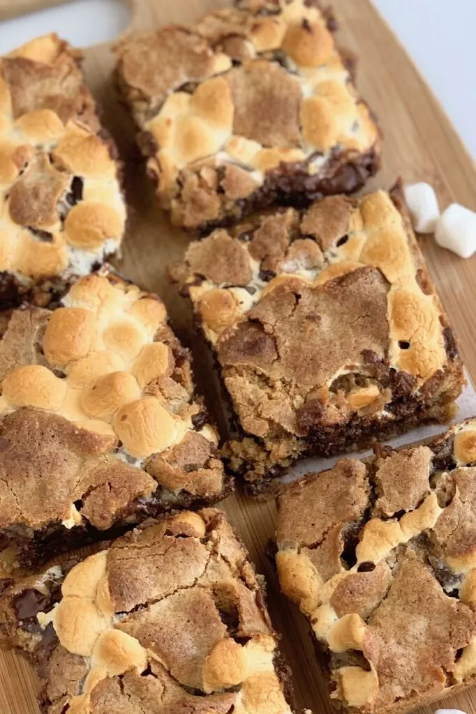 Cut S'more Bars with a graham cracker crust, ooey gooey mini marshmallows, melted chocolate chunks, and a cookie topping.