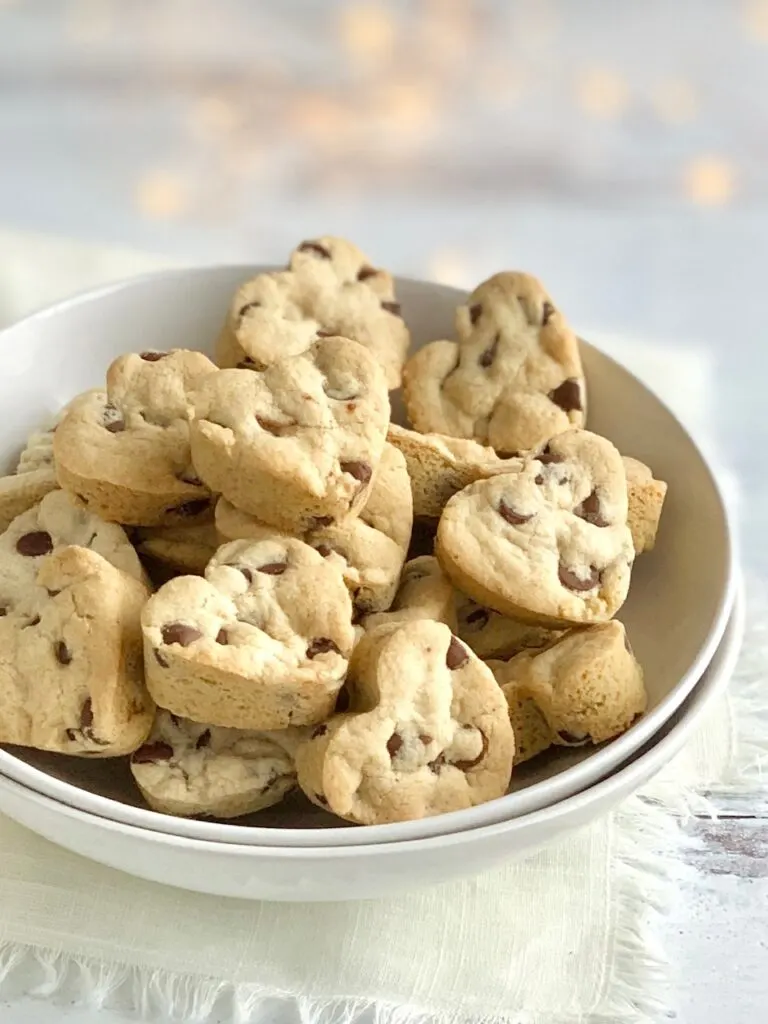 A bowl of heart-shaped chocolate chip cookies. 