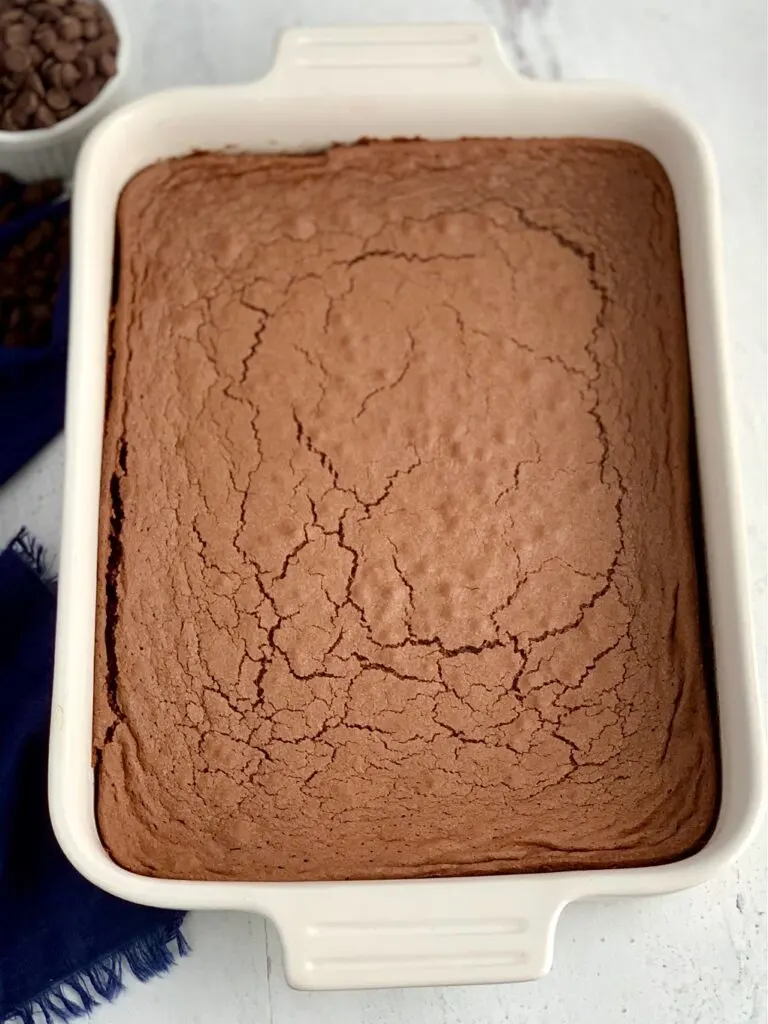 A baked chocolate brownie mix in a white 9X13-inch baking pan