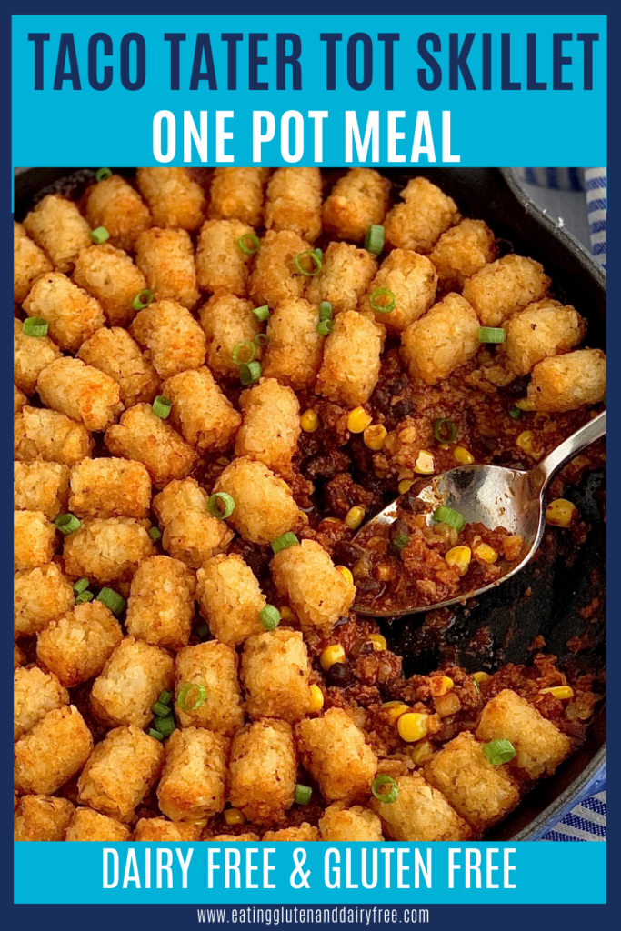 Crispy tater tots on top of a taco mixture of ground beef, corn, black beans, and a sauce mixture with a serving spoon in it.