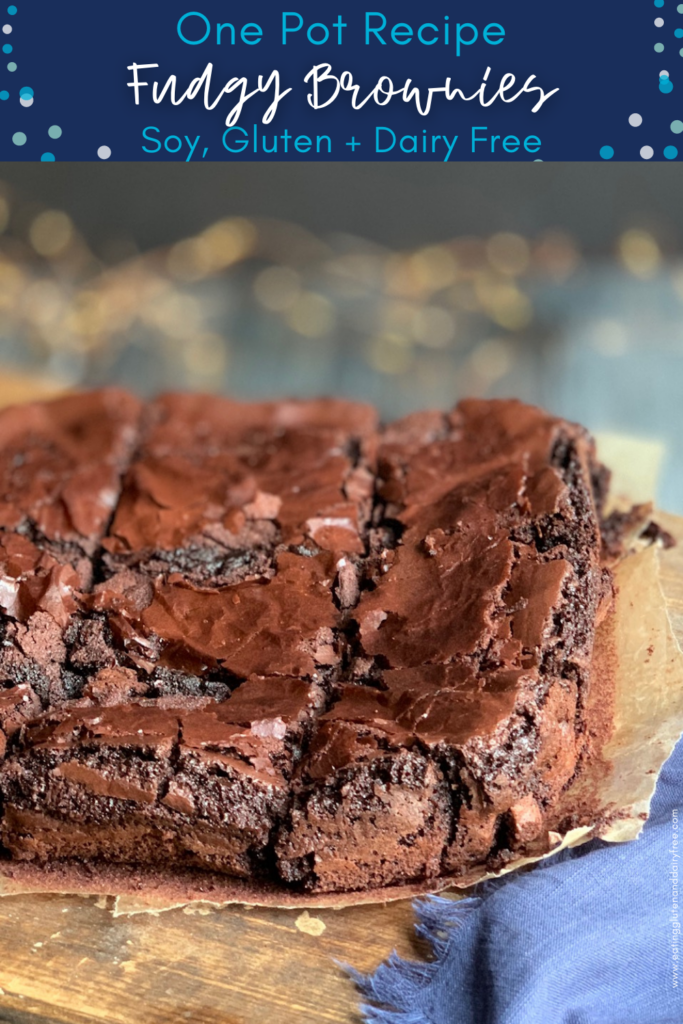 A close up of an  8x8-inch square baked brownie cut into 12 slices on a cutting board.