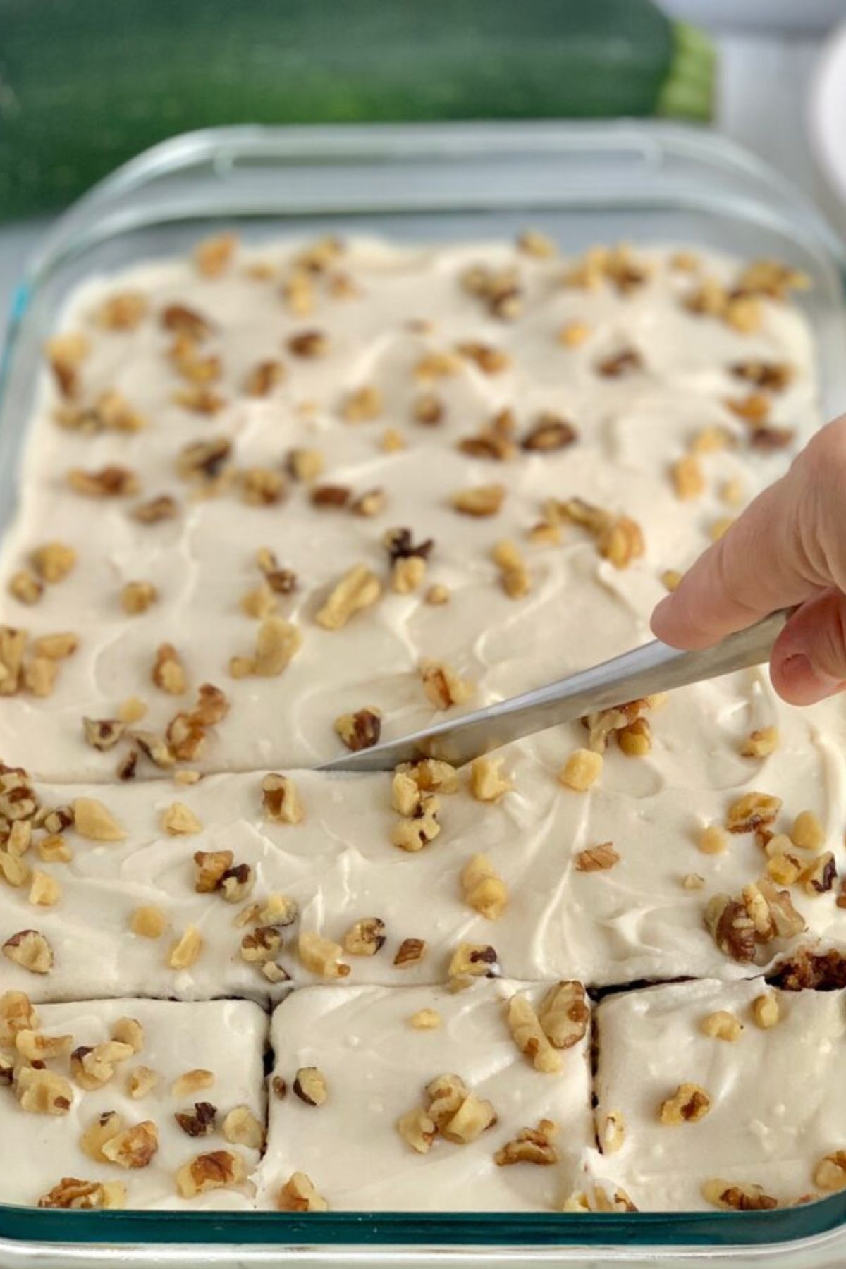 Gluten Free Zucchini Bars being cut in a baking pan.