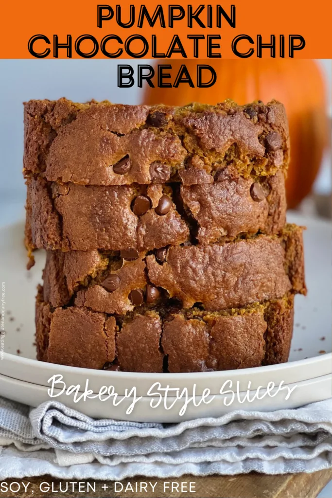 4 large, thick slices of pumpkin bread with chocolate chips stacked on top of each other with a pumpkin behind it.