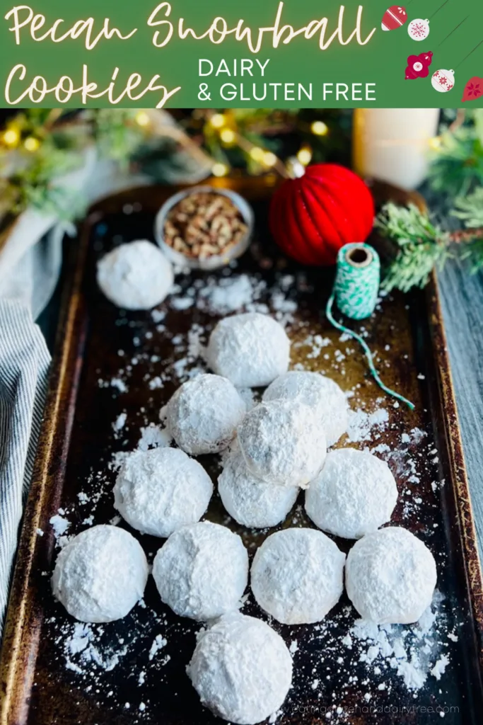 A dark baking sheet with white round cookies styled in the shape of a Christmas tree and white and green twine nearby.