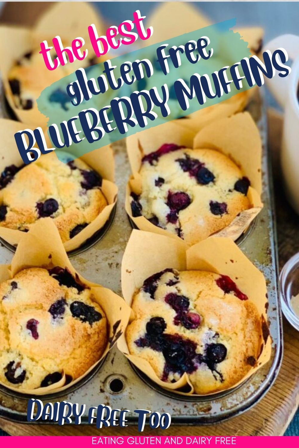 A tin of gluten and dairy free blueberry muffins with text overlay. 