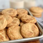 A small baking pan filled with round baked cookies with a crackly cinnamon and sugar topping.