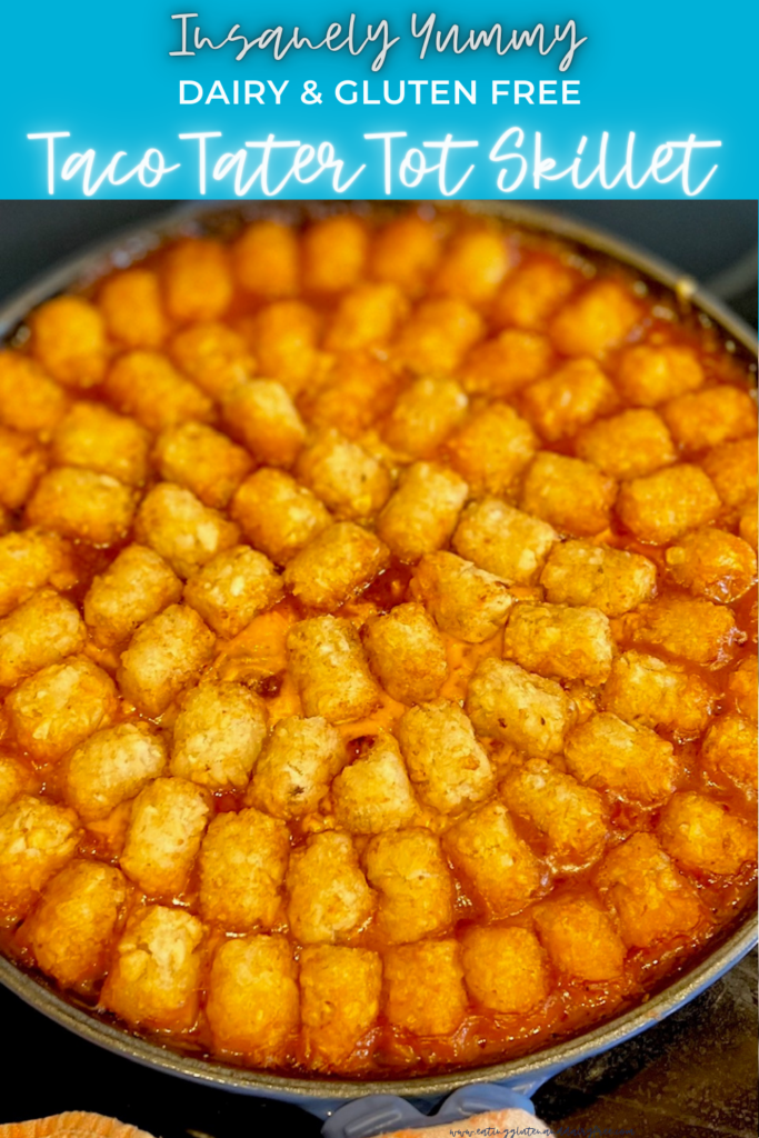 A close up of baked tater tots in a circle with red sauce and yellow melted cheese in a pan.