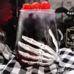 Skeleton sticker on drink glass with drink inside.
