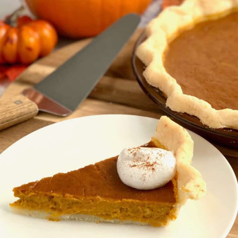 A slice of Gluten Free Pumpkin pie on a plate.