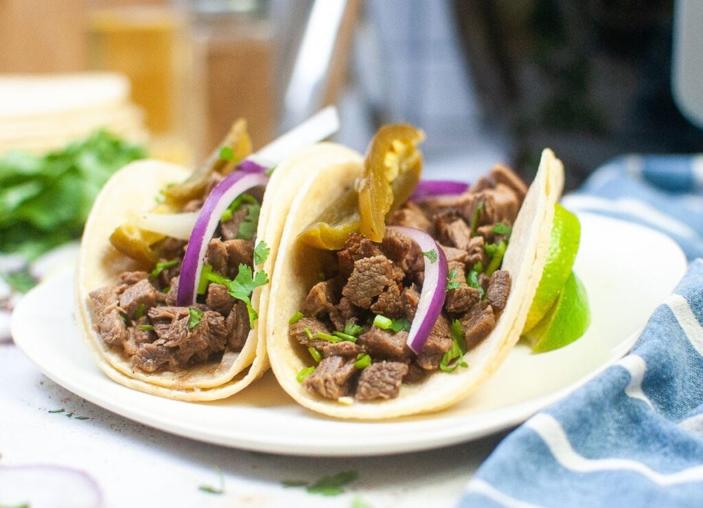 Looking at a plate of Air Fryer Beef Street Tacos.