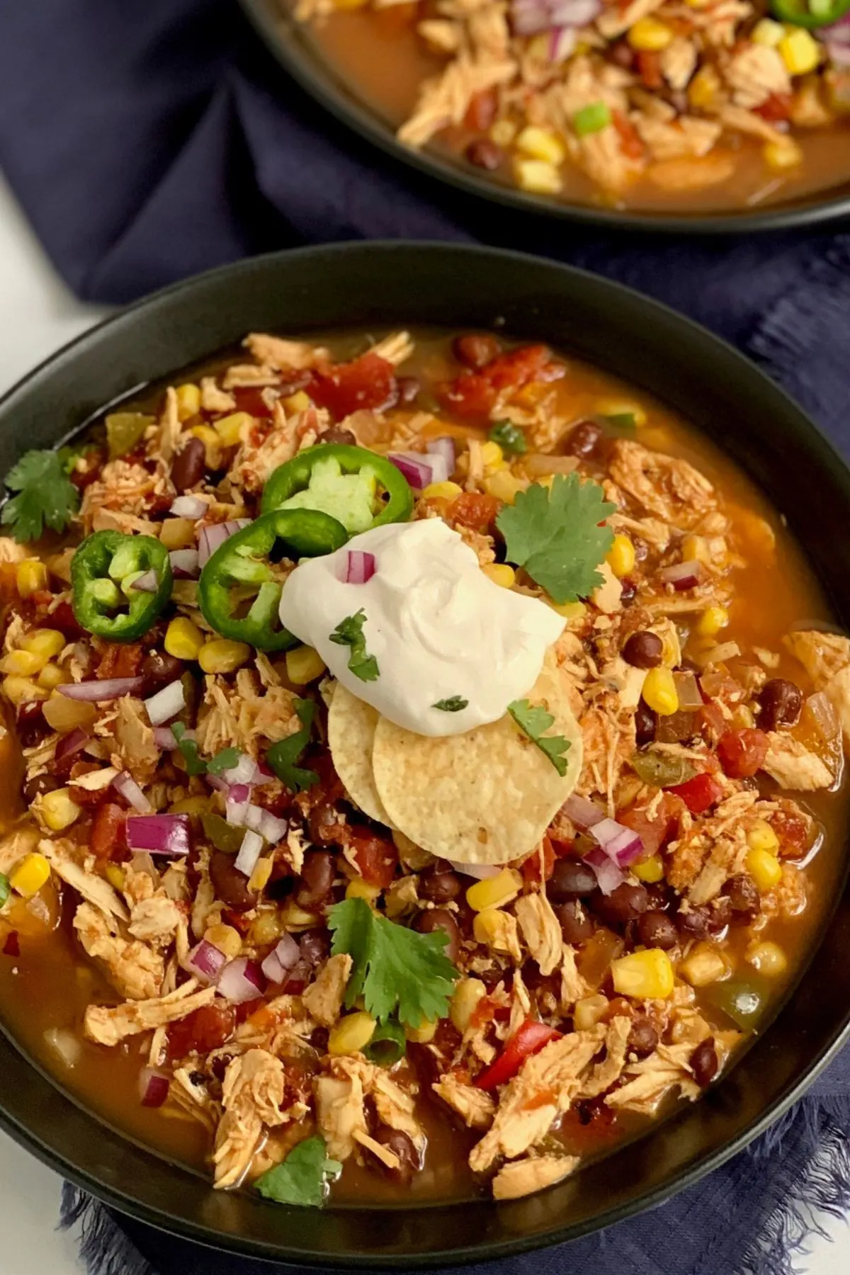 Bowl of soup with dairy free sour cream and gluten free chips.