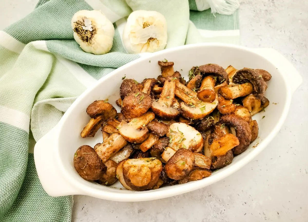 White dish of air fried mushrooms.