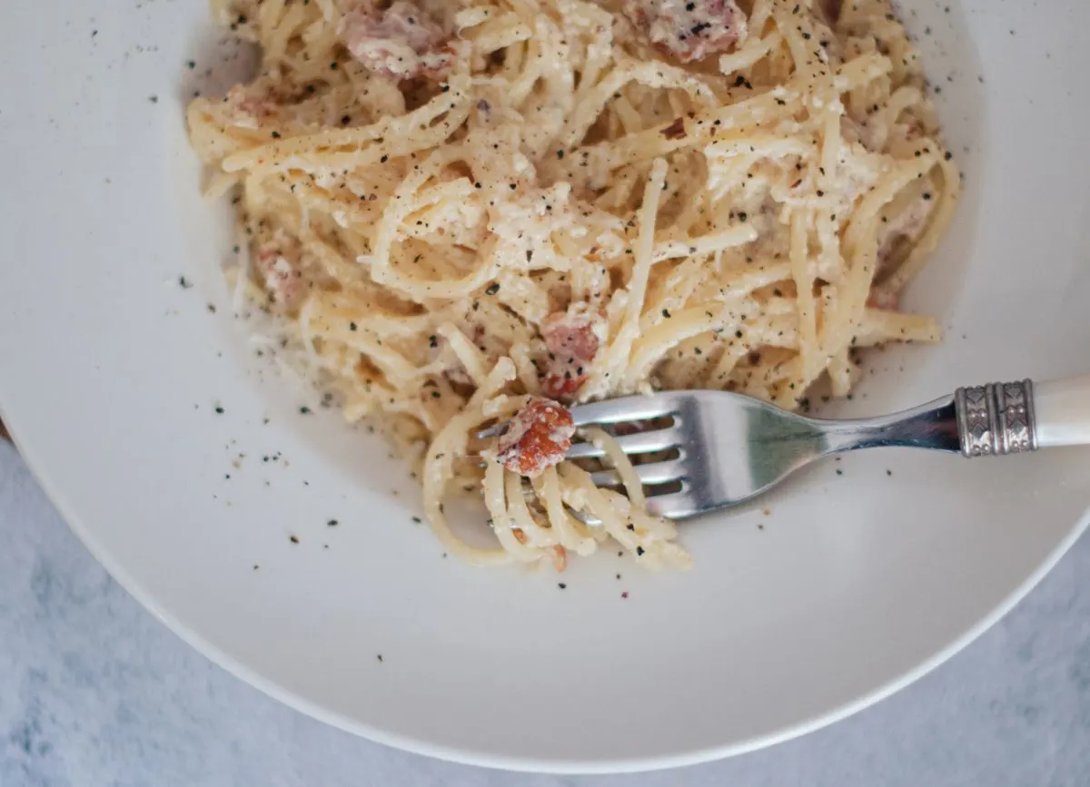 Close up bite shot of gluten free pasta carbonara.