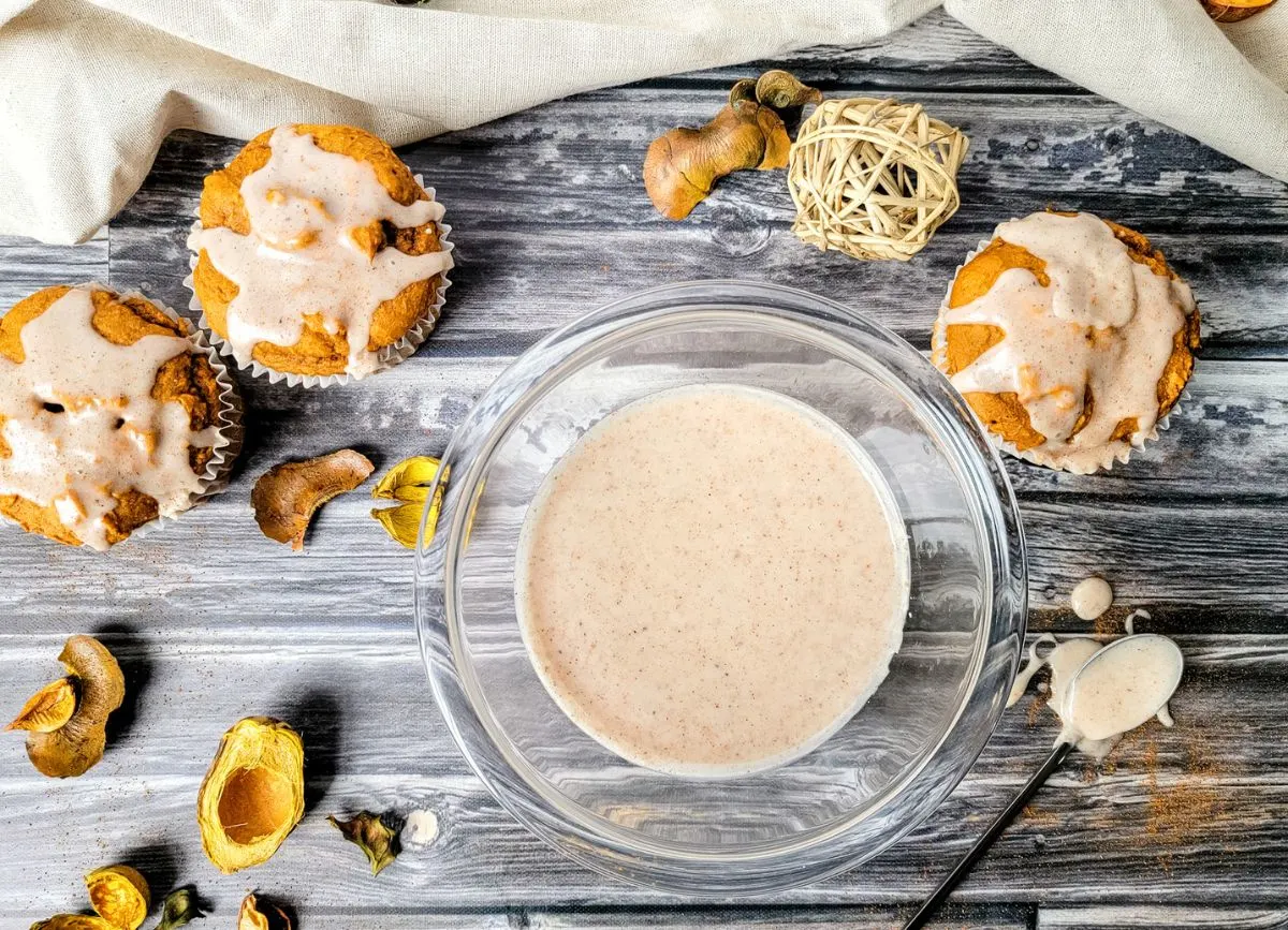 Bowl of glaze with glazed muffins.