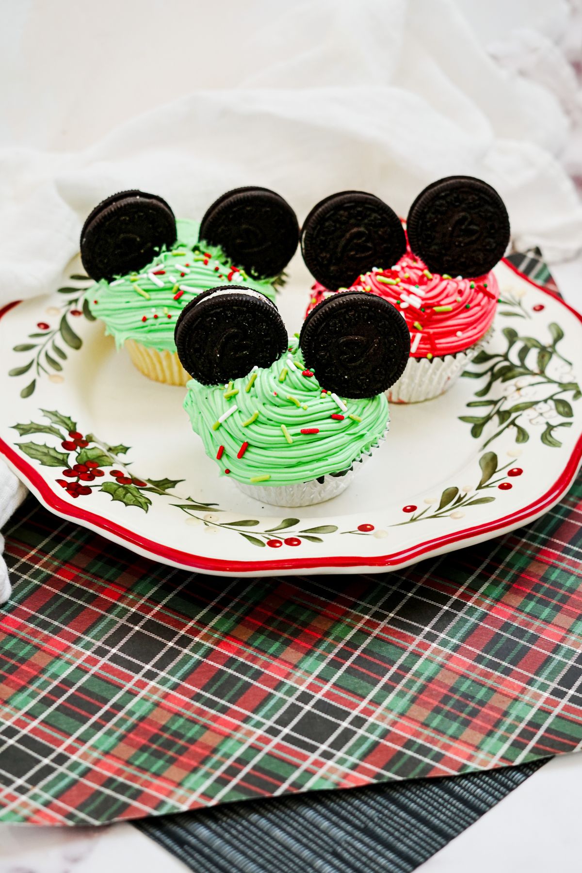 Plate with Green and Red Mickey Mouse Cupcakes for Christmas.