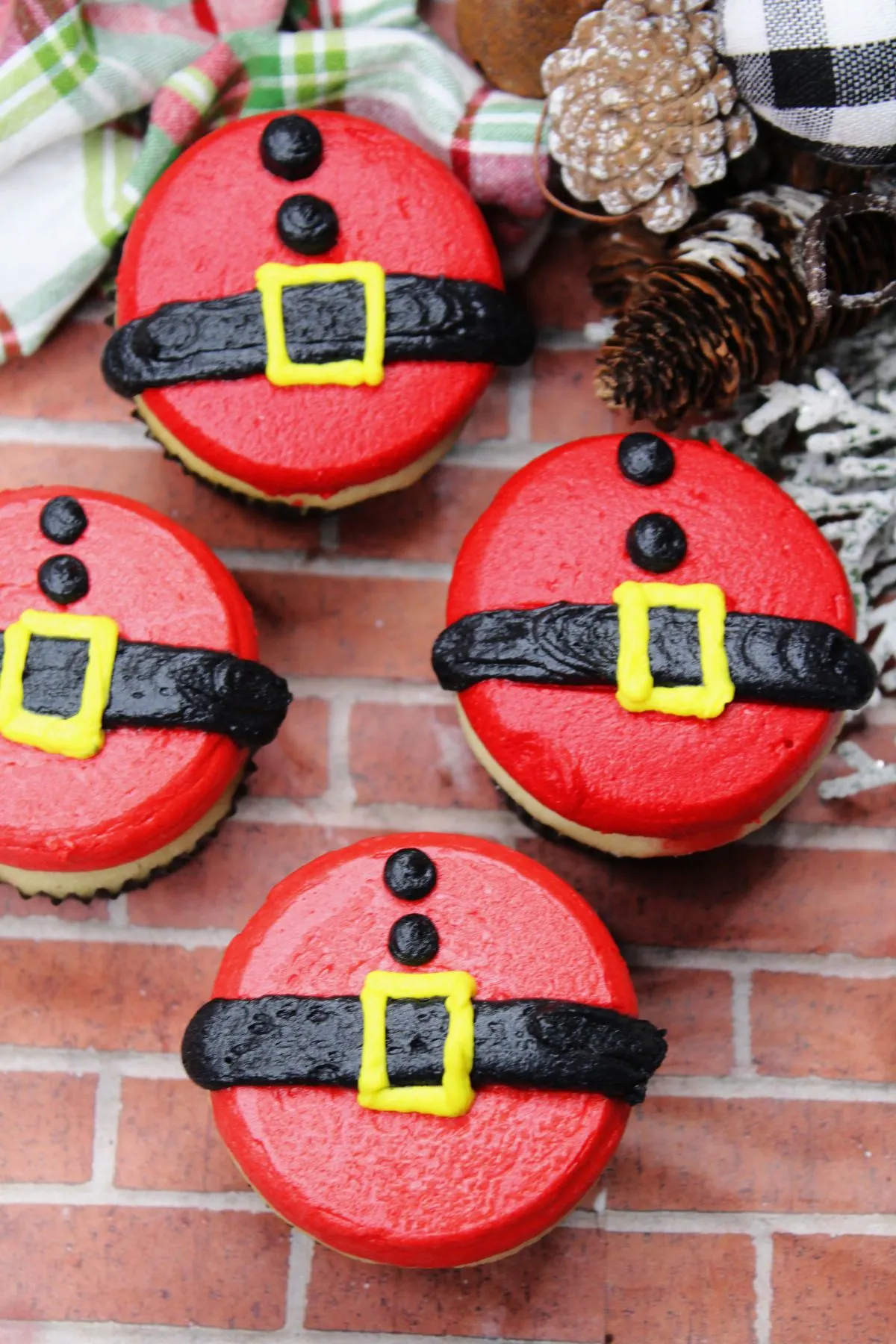 A few homemade gluten and dairy free cupcakes decorated to look like Santas belly and his belt.