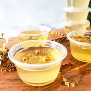 A close up of a Champagne Jello Shot with gold sprinkles.