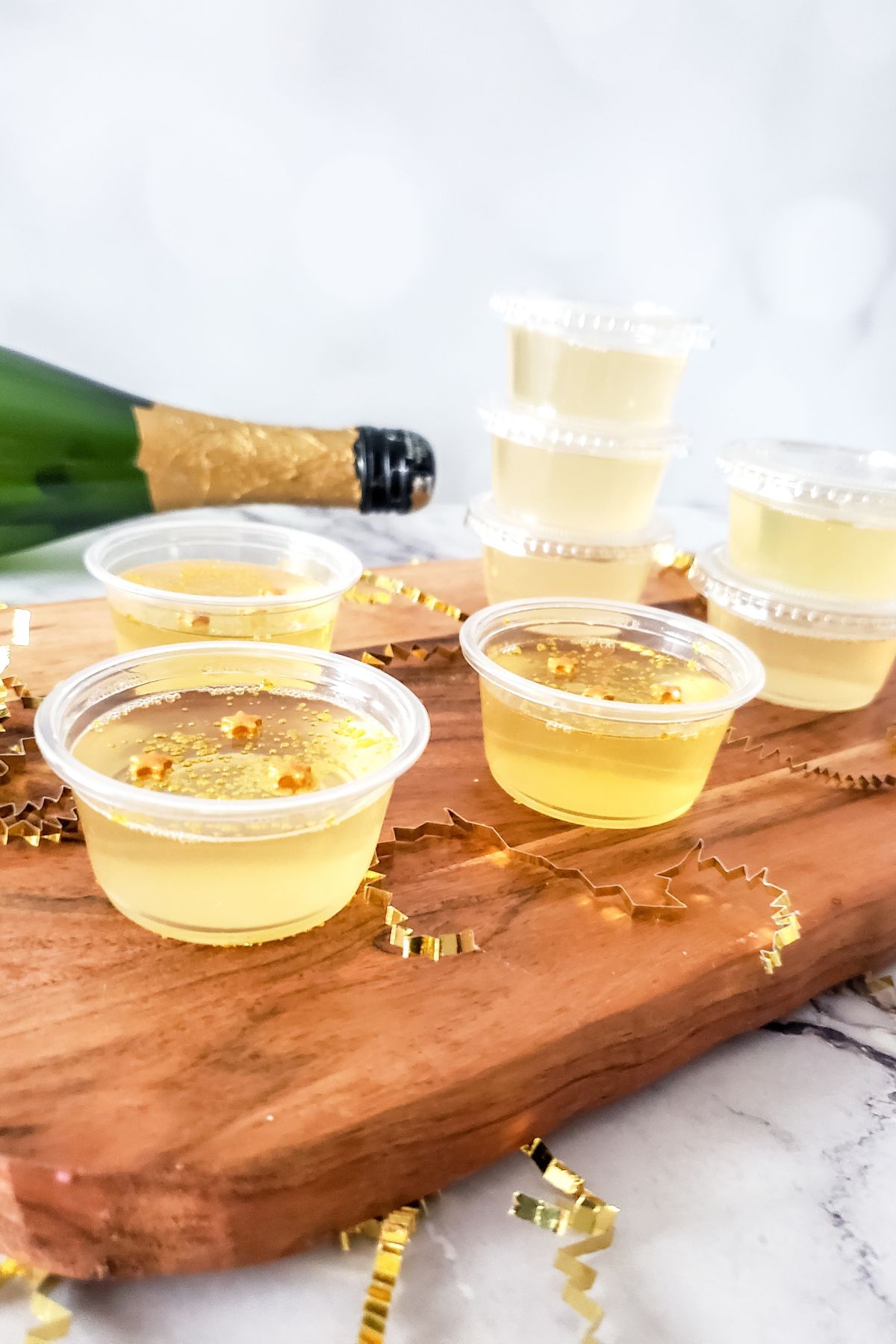 Plastic containers with champagne jello shots.