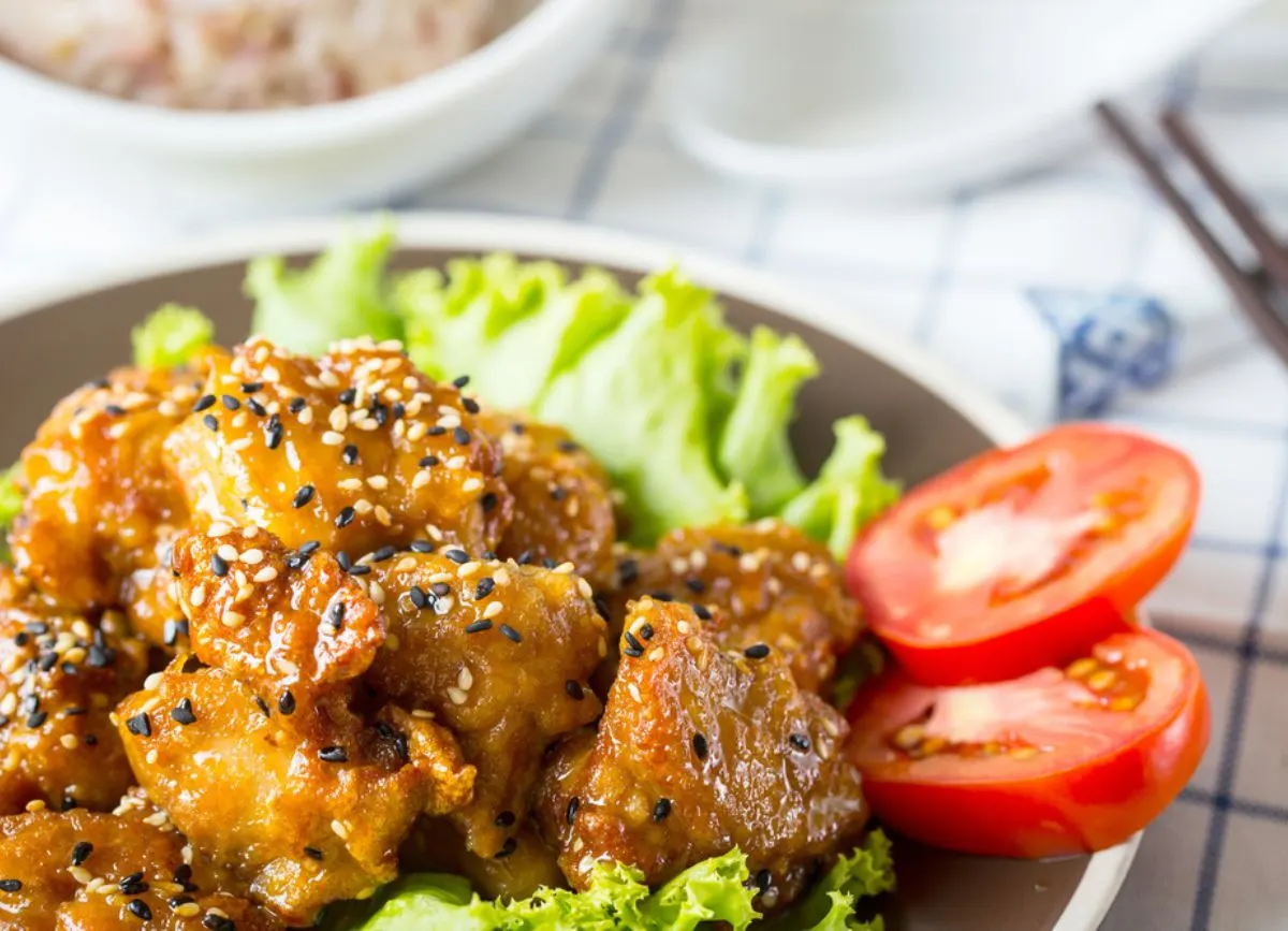 A plate of food with sesame seeds on top.