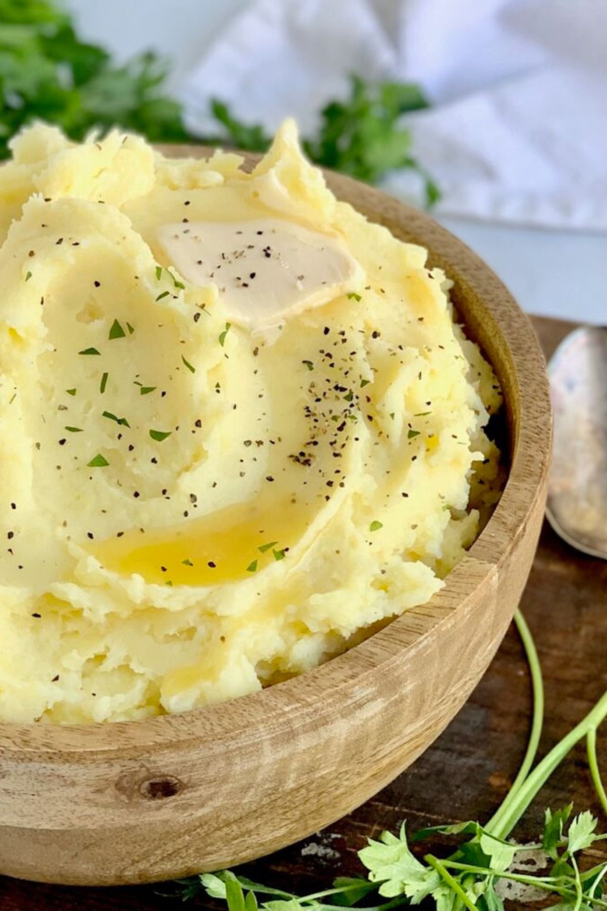 A wooden bowl of dairy free mashed potatoes.