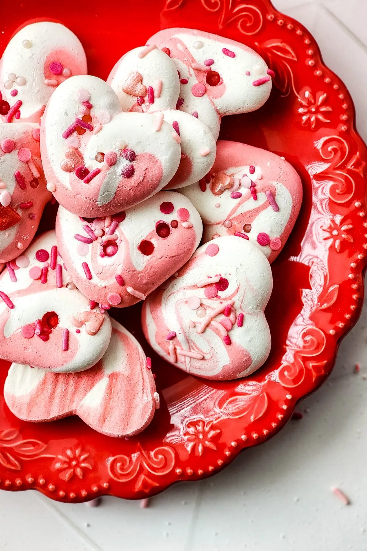 A valentine's day plate full of meringue soft cookies.