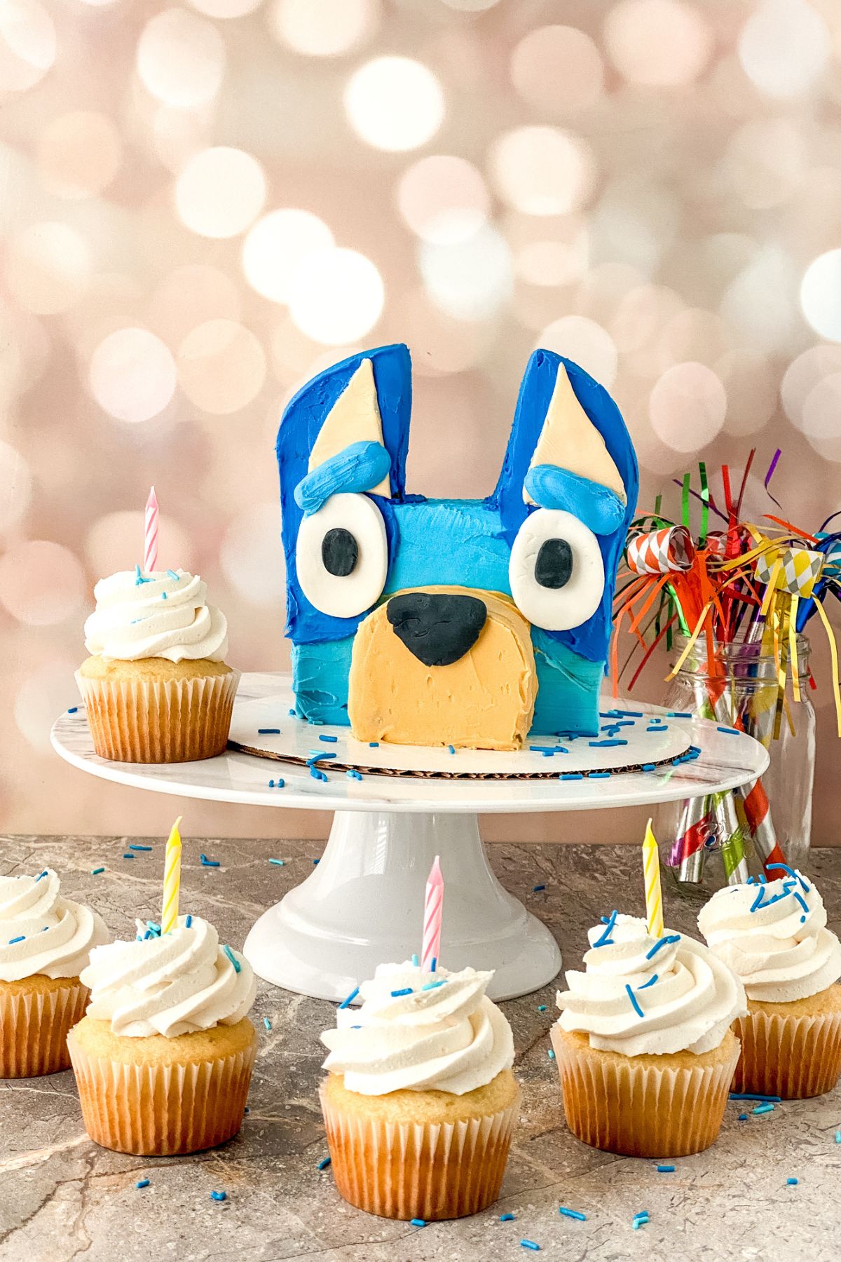 A cake in the shape of Bluey's head.