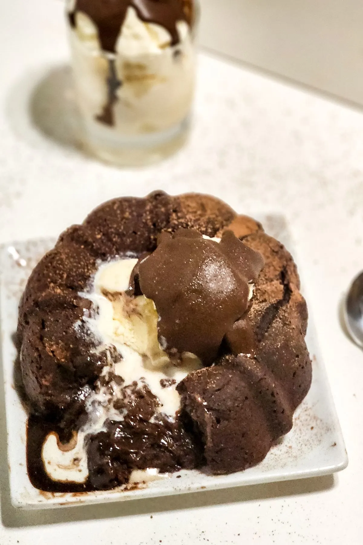 A plate with a chilis copycat gluten free chocolate molten lava cake. 