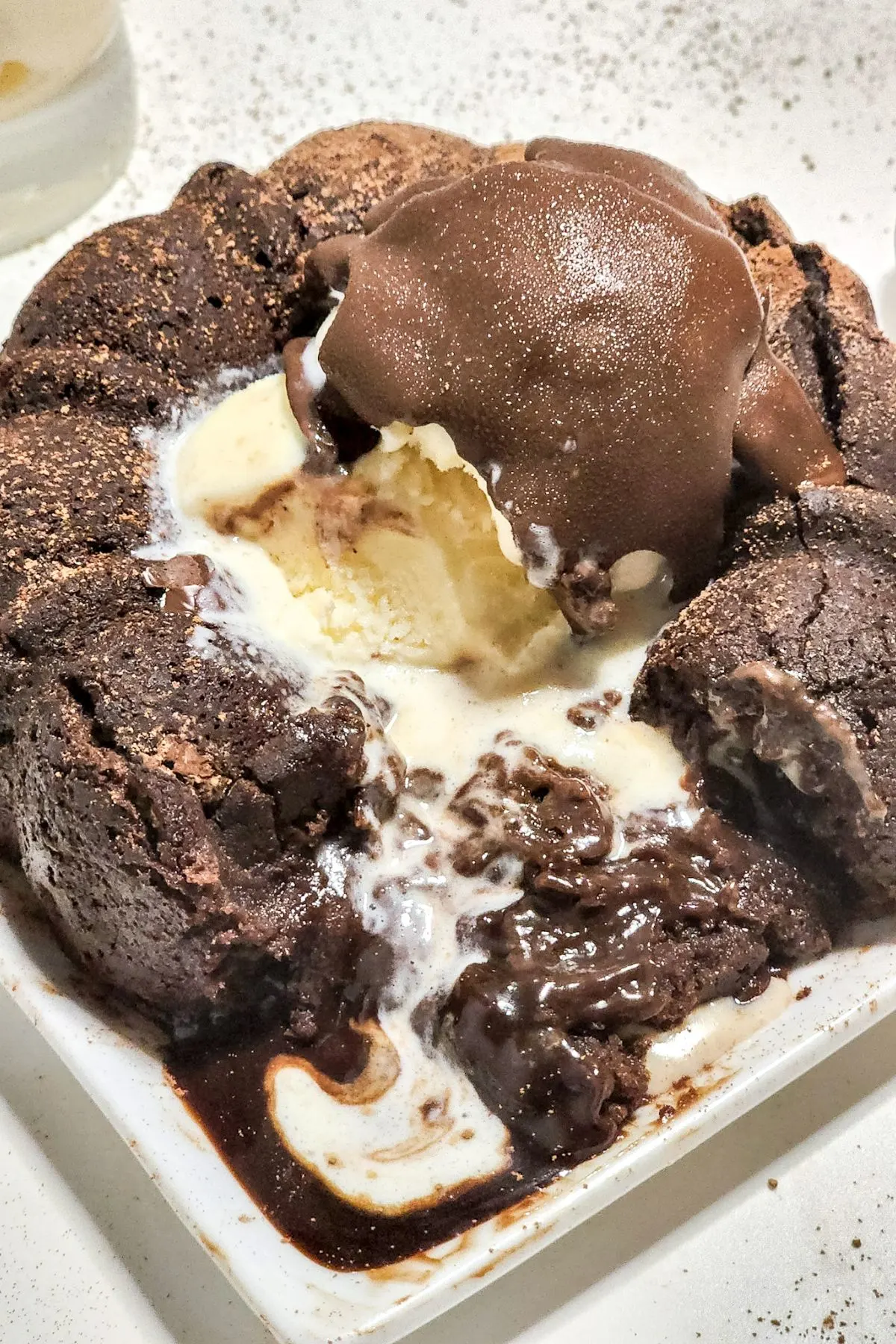 An oozing chocolate molten lava cake on a plate. 