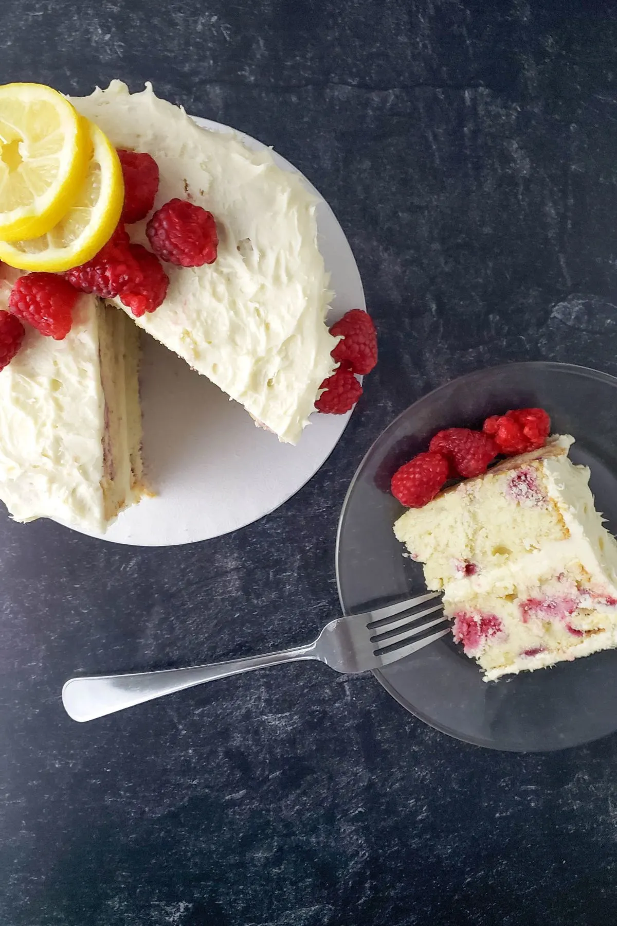 A plate with a gluten free dairy free lemon raspberry cake.