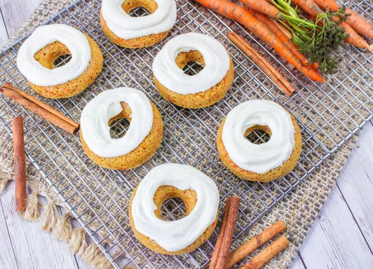 Quite a few baked carrot cake donuts.