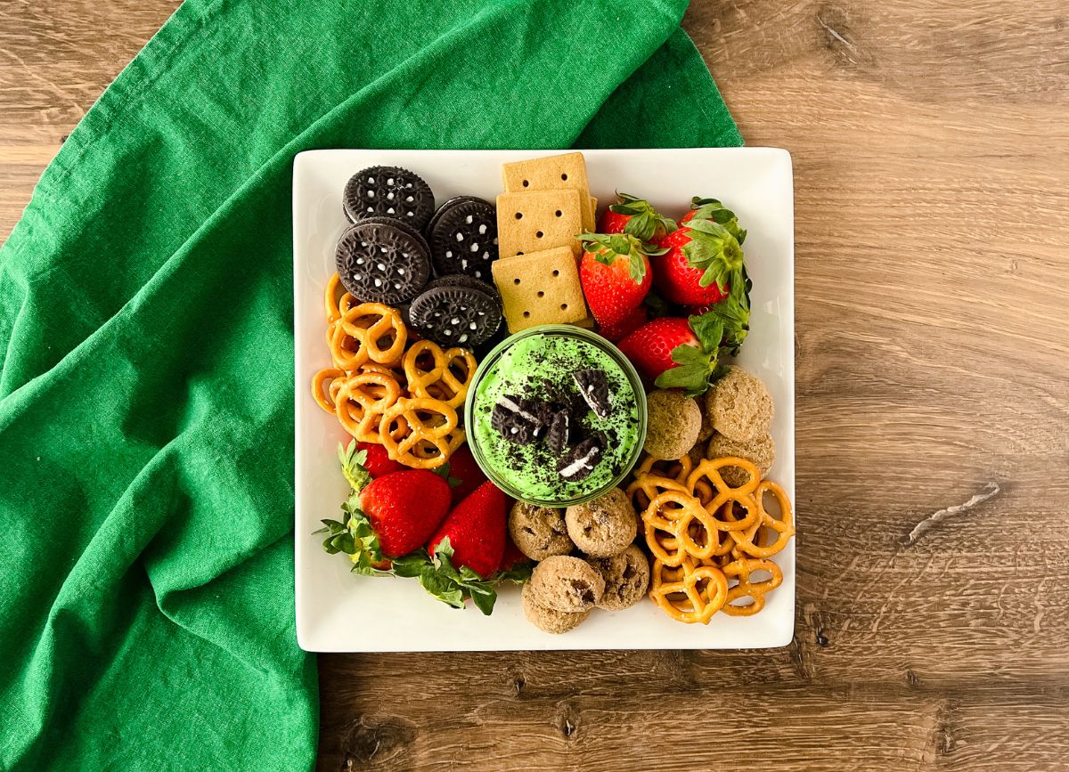 Looking down on a plate of treats and green St Patricks Day dessert dips.