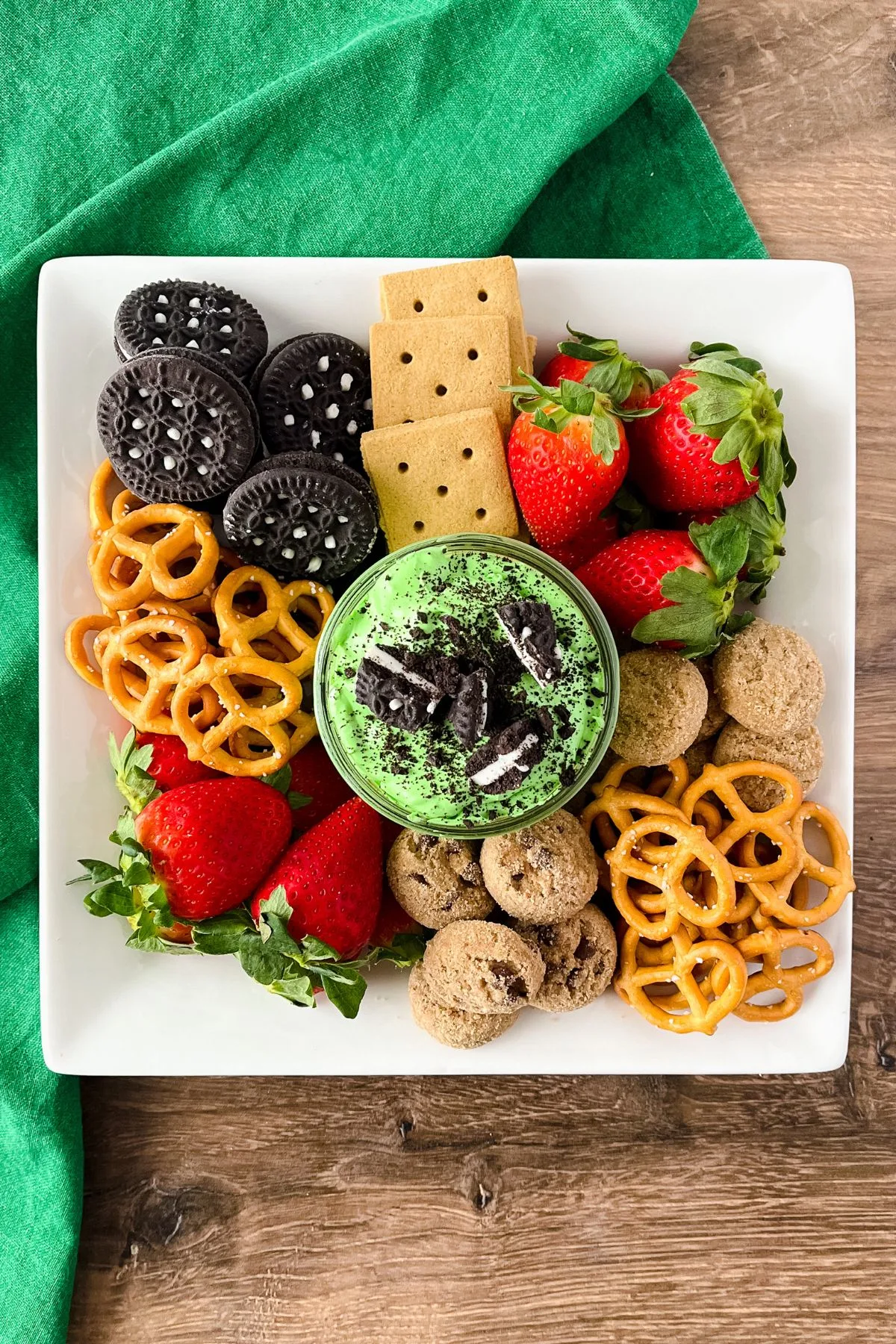 A plate of gluten and dairy free snacks with a jar of St Patricks Day dessert dip.