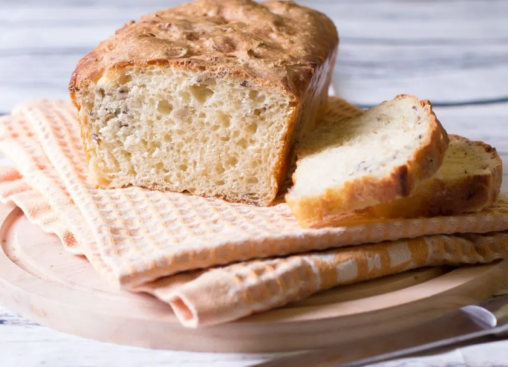 A loaf of white bread with a few slices. 