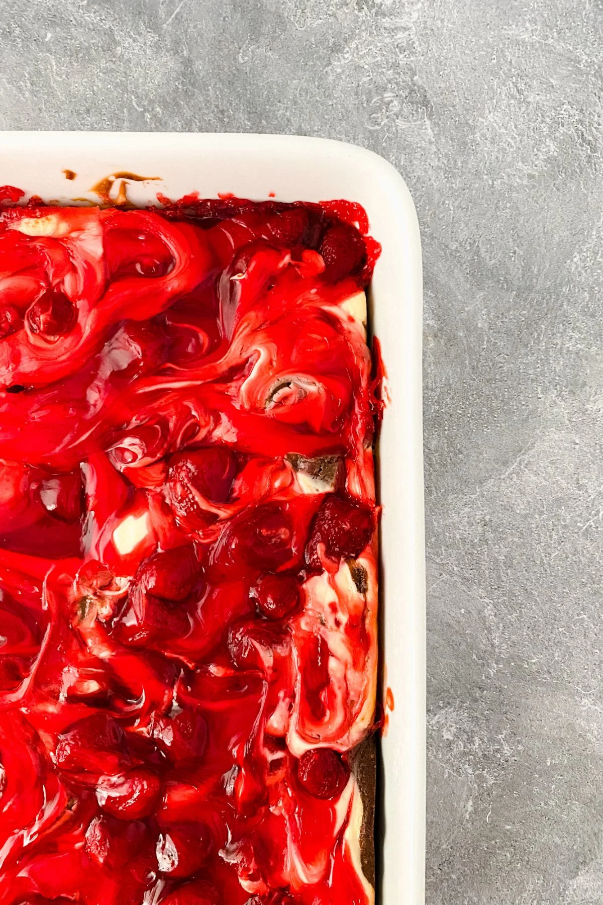 A baking dish with gluten and dairy free strawberry cheesecake brownies.