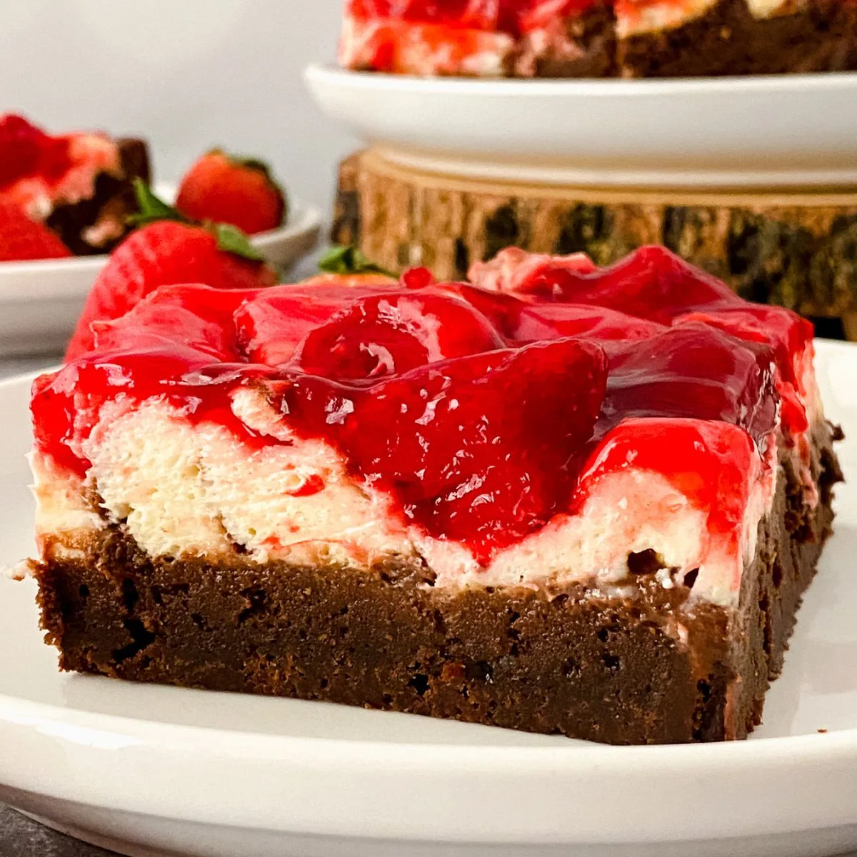 Close up looking at a slice of gluten free strawberry cheesecake brownie.