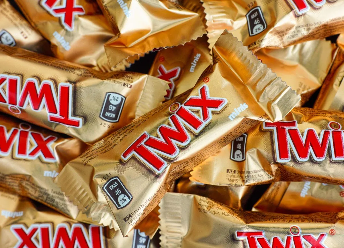 A bunch of mini Twix bars in a pile.